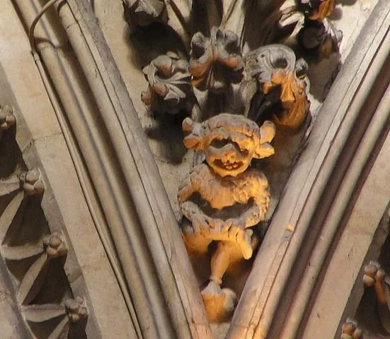 Stone carving of a demonic creature on a cathedral pillar