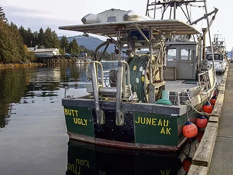 Photo of a fishing boat with the name Butt Ugly moored at a quay in Juneau, Alaska