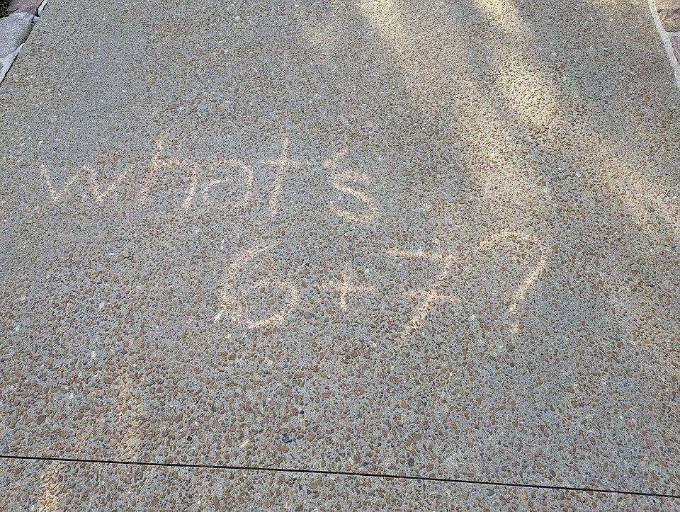 “What’s 6+7?” scrawled on a sidewalk in chalk on the campus of Washington University in St. Louis