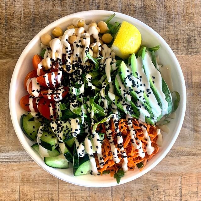 Mediterranean Bowl- this yummy salad has brown rice and quinoa topped with arugula, avocado, carrots, onions, chick peas, cucumbers, cherry tomatoes, black sesame seeds, and lemon tahini sauce.