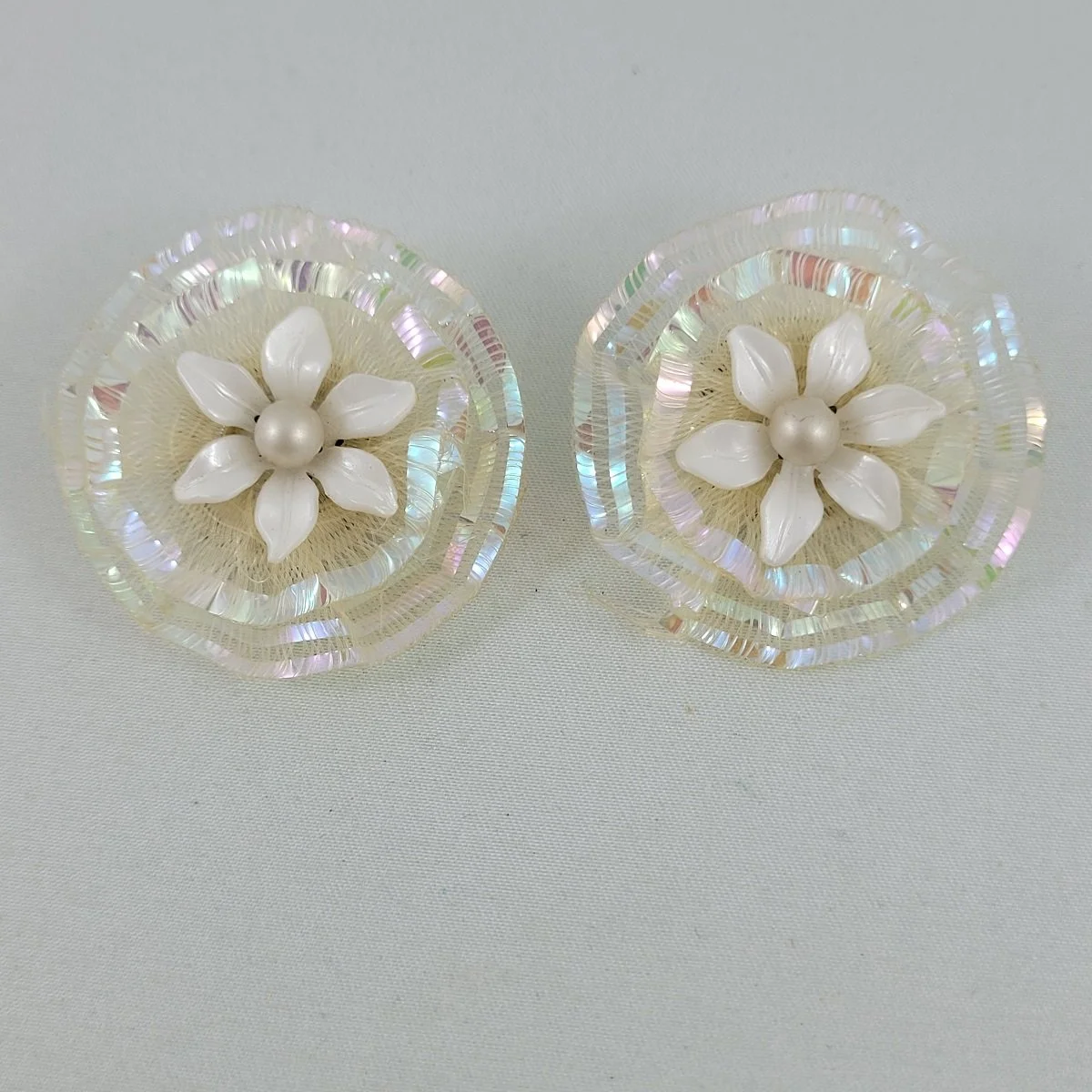 1950's White Plastic Pearl Flower Layered Iridized Soft Plastic Looped Threads 1.5 Inch Clip Earrings.jpg