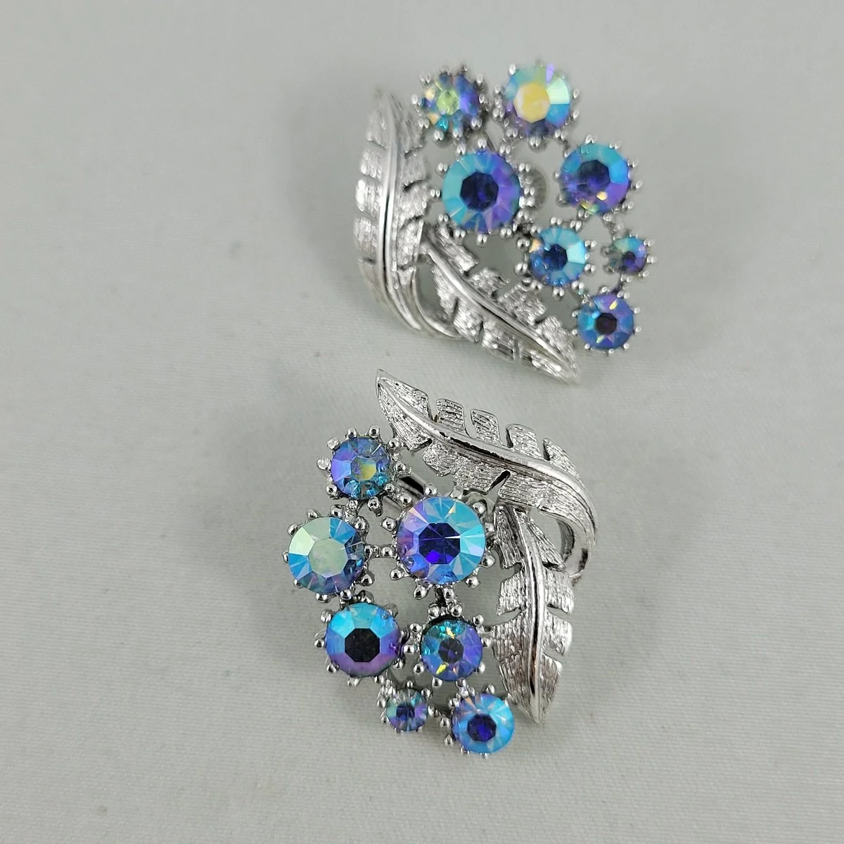 Coro Unsigned Blue Aurora Borealis Textured Double Leaf Rhodium Plated Floral Spray Clip-on Earrings