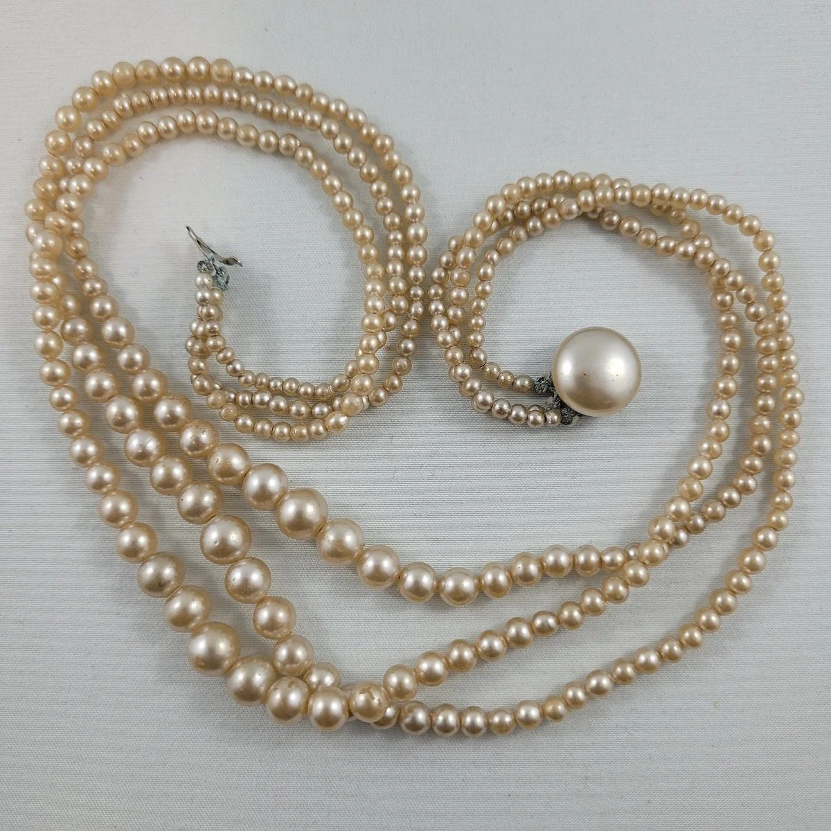 1950's Triple Strand Graduated Luminescent Peach Simulated Pearl Glass Bead 16 Inch Necklace Round Box Clasp.jpg