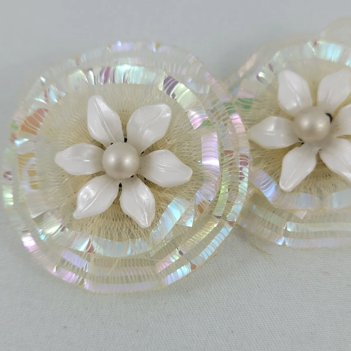 1950's White Plastic Pearl Flower Layered Iridized Soft Plastic Looped Threads 1.5 Inch Clip Earrings -2.jpg