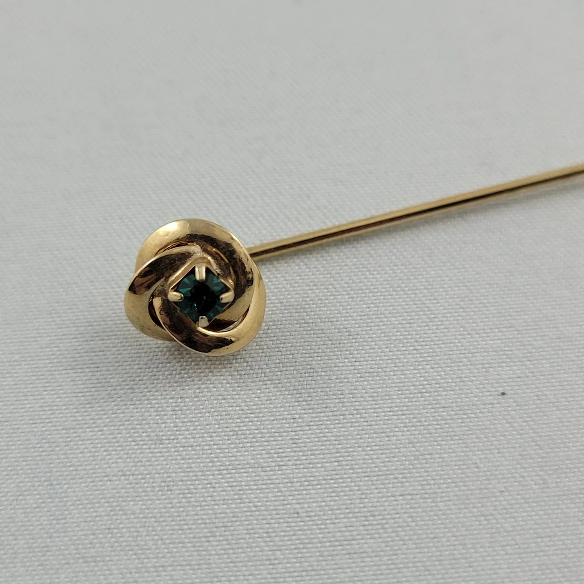 1960's Gold-tone Pinwheel Swirl Prong Set Green Emerald Rhinestone 2 Inch Jabot Stick Pin Close Up