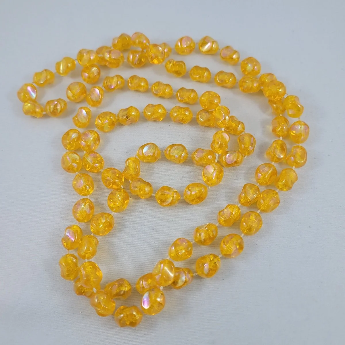 1950's - 1960's Iridized Amber Plastic Pinched Nugget Fixed Bead 47 Inch Beaded Rope Necklace Close Up
