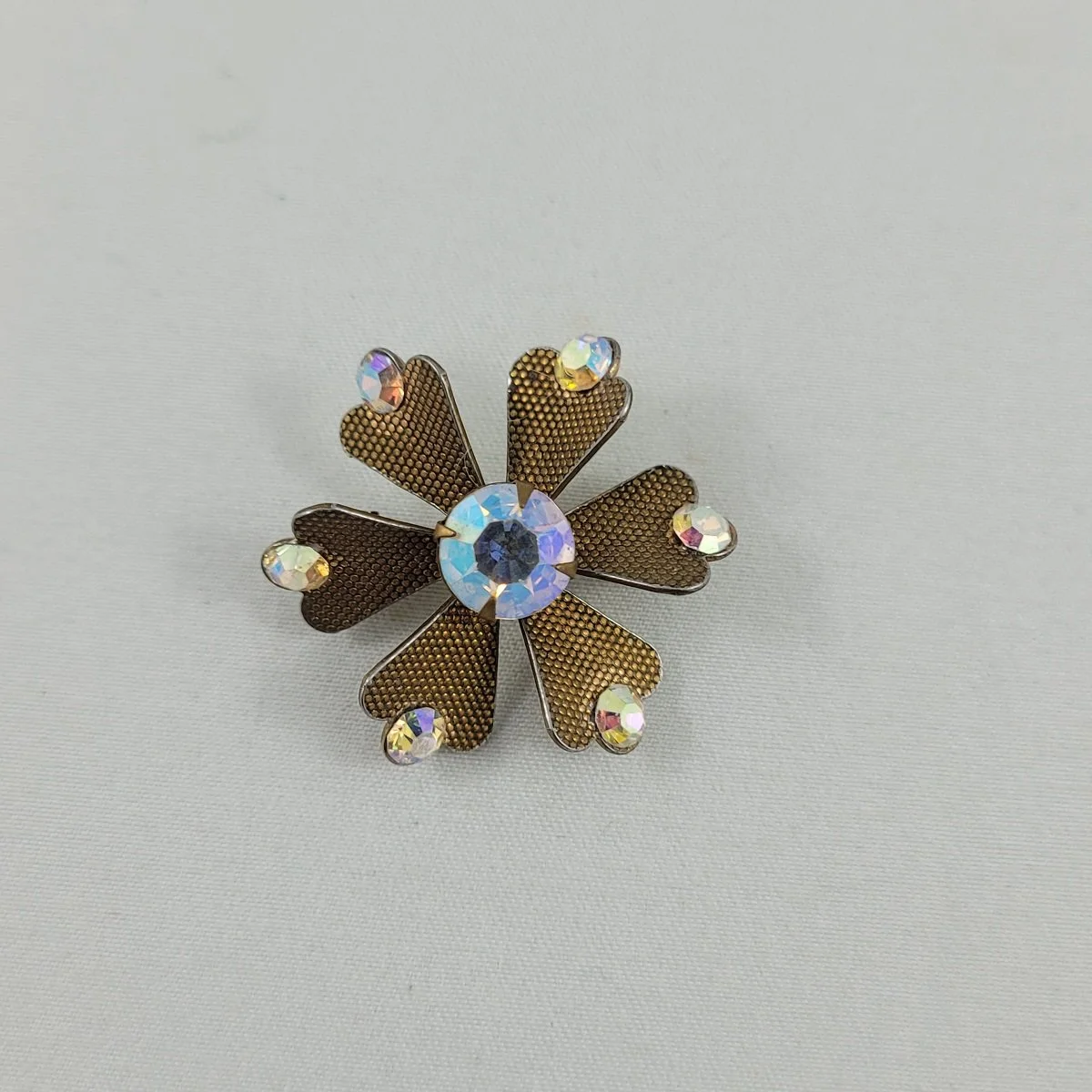 1955 - 1960's Aurora Borealis Rhinestone Pinwheel Firework Textured Gold Twisted Panel 1.25 Inch Flower Brooch