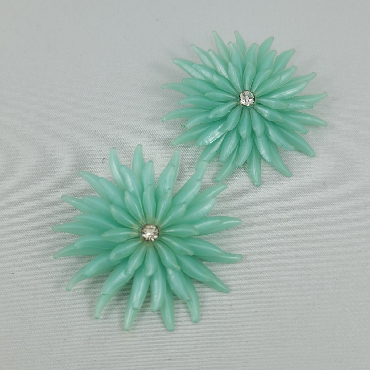 1950's Aqua Green Soft Plastic Triple Layer Chrysanthemum Flower Rhinestone 1.75 Inch Clip-on Earrings Side View