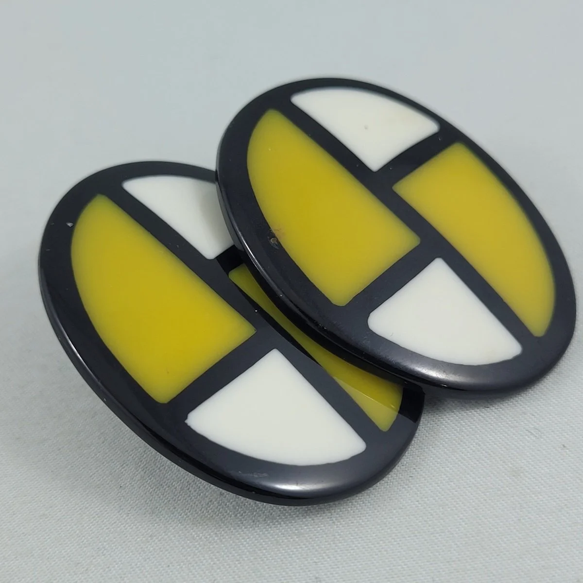 1980's Colour Block Black Yellow and White Laminated Lucite 1.75 Inch Oval Pierced Earrings Side View