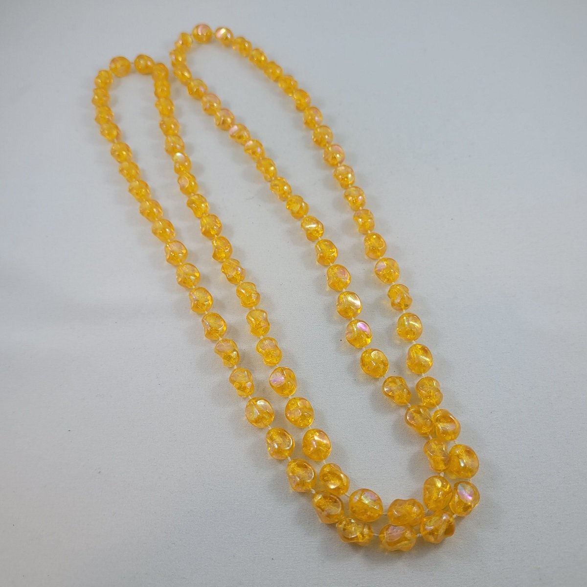 1950's - 1960's Iridized Amber Plastic Pinched Nugget Fixed Bead 47 Inch Beaded Rope Necklace Front View