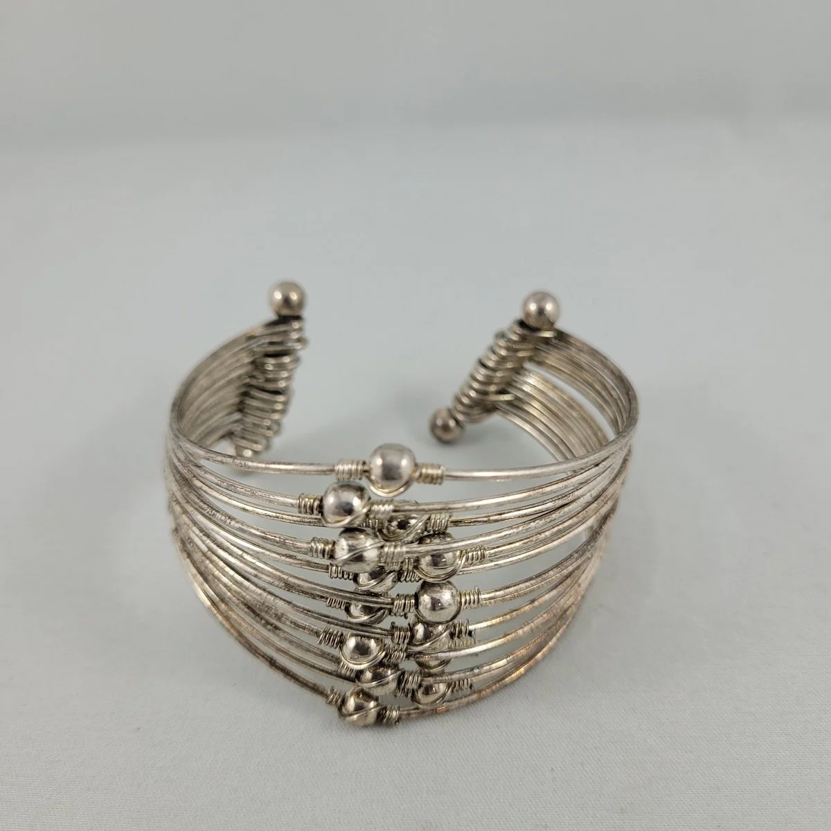 Modernist Silvertone Multi Strand Articulating Hoops Fixed Ball Double Barbell Open Cuff Bracelet.jpg