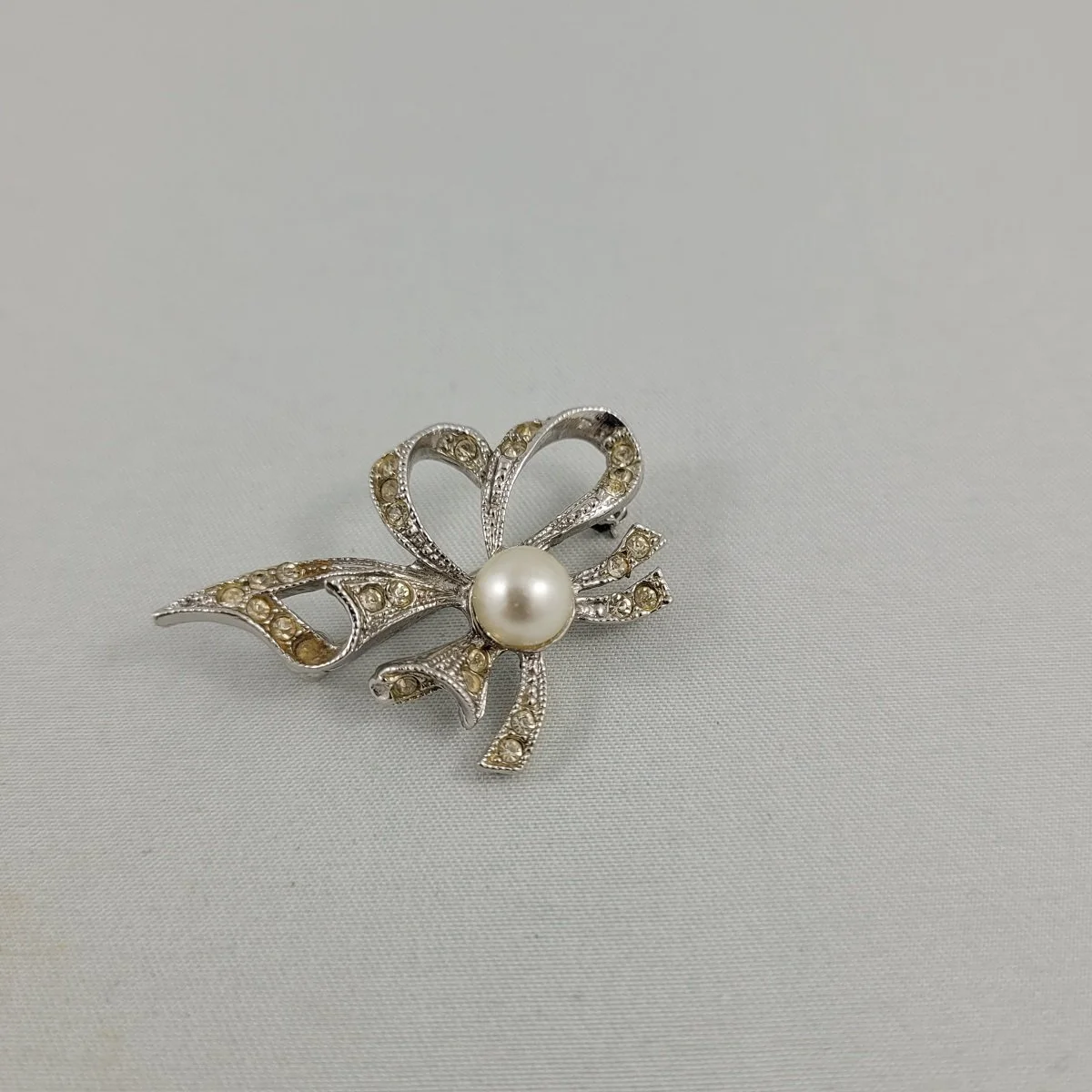 1940's - 1950's Ribbon Bow Pave Clear Rhinestone Faux Marcasite Pearl Silver-tone 1.5 Inch Brooch Side View