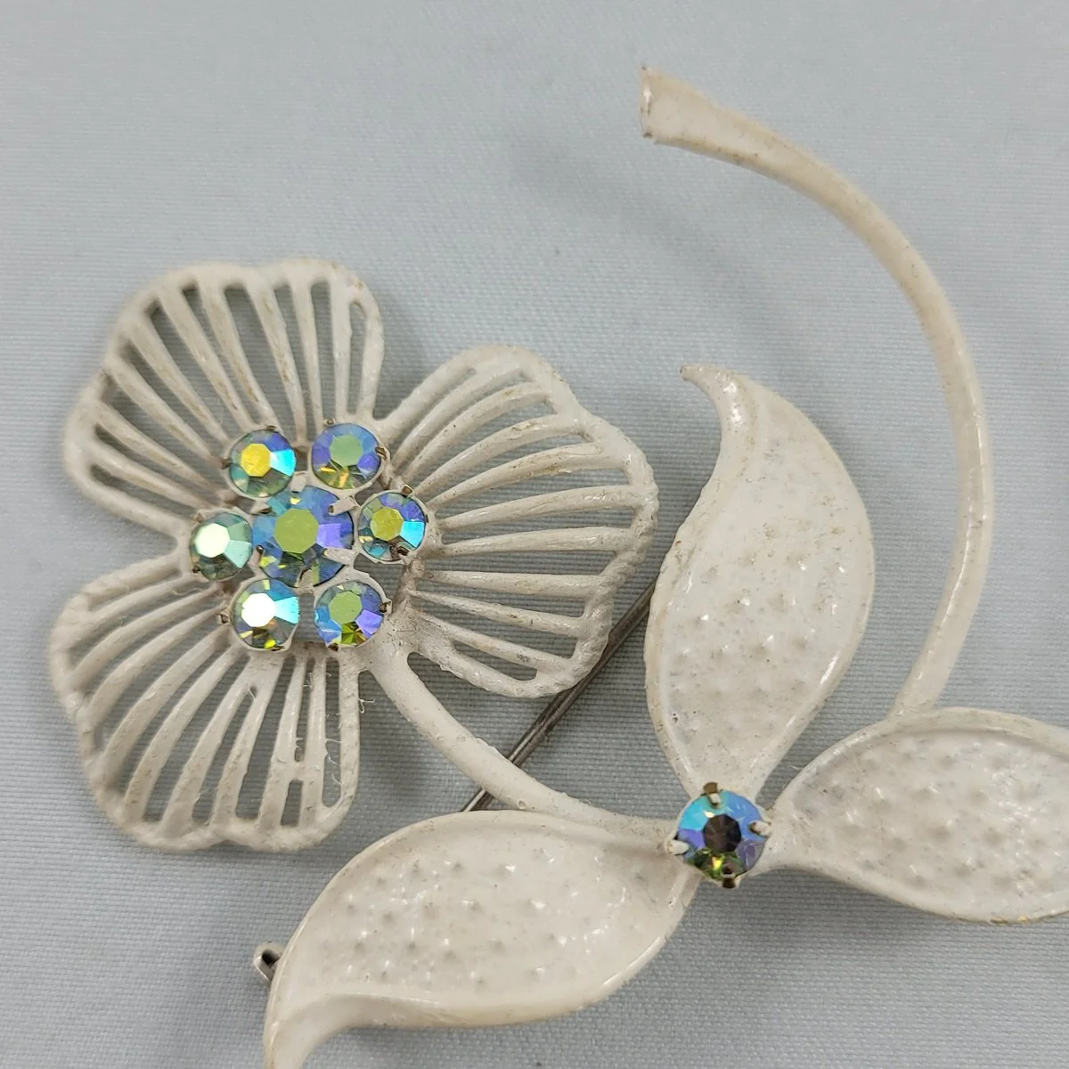 1955 - 1960's Prong Set Aurora Borealis Rhinestone White Enameled Brass 2.5 Inch Stemmed Flower Brooch Close Up