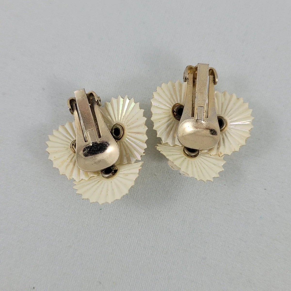 1950's Domed Triple Flower Riveted Rhinestone Iridized Shiny Soft White Plastic 1 Inch Clip Earrings -2.jpg