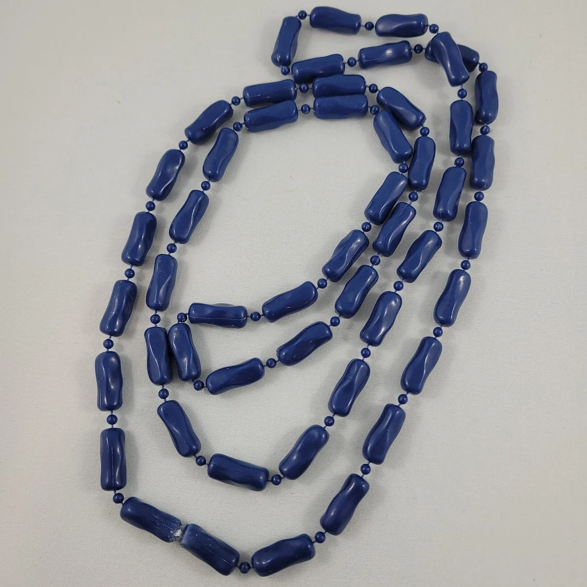 Early Moulded Plastic Navy Blue Oblong Tubular Fixed Dimpled Bead 47 Inch Continuous Loop Rope Necklace.jpg