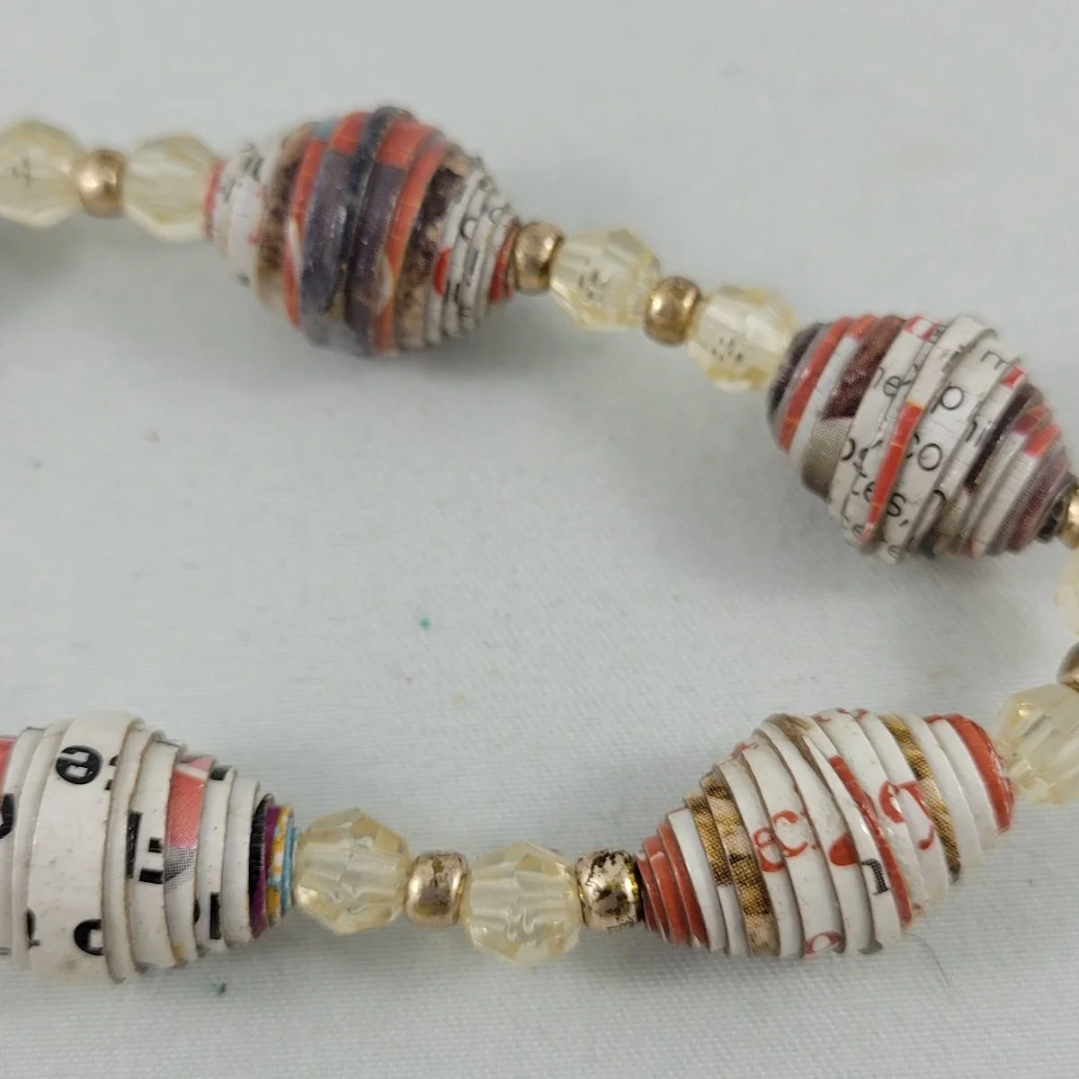 Vintage Magazine Paper Wrap Coated Boho Bead Clear Gold Plastic Beaded Stretch Elasticized Bracelet Close Up