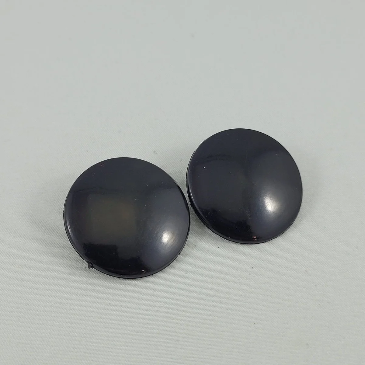 1950's Black and White Nylon Plastic 1.125 Inch Round Clip Earrings.jpg