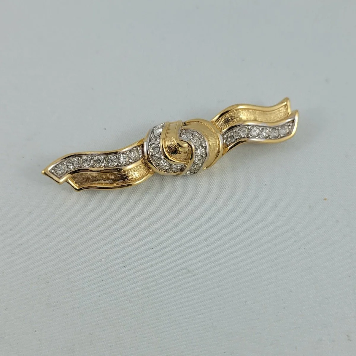 Nina Ricci Crystal Rhinestone Knotted Wavy Ribbon Gold Brooch