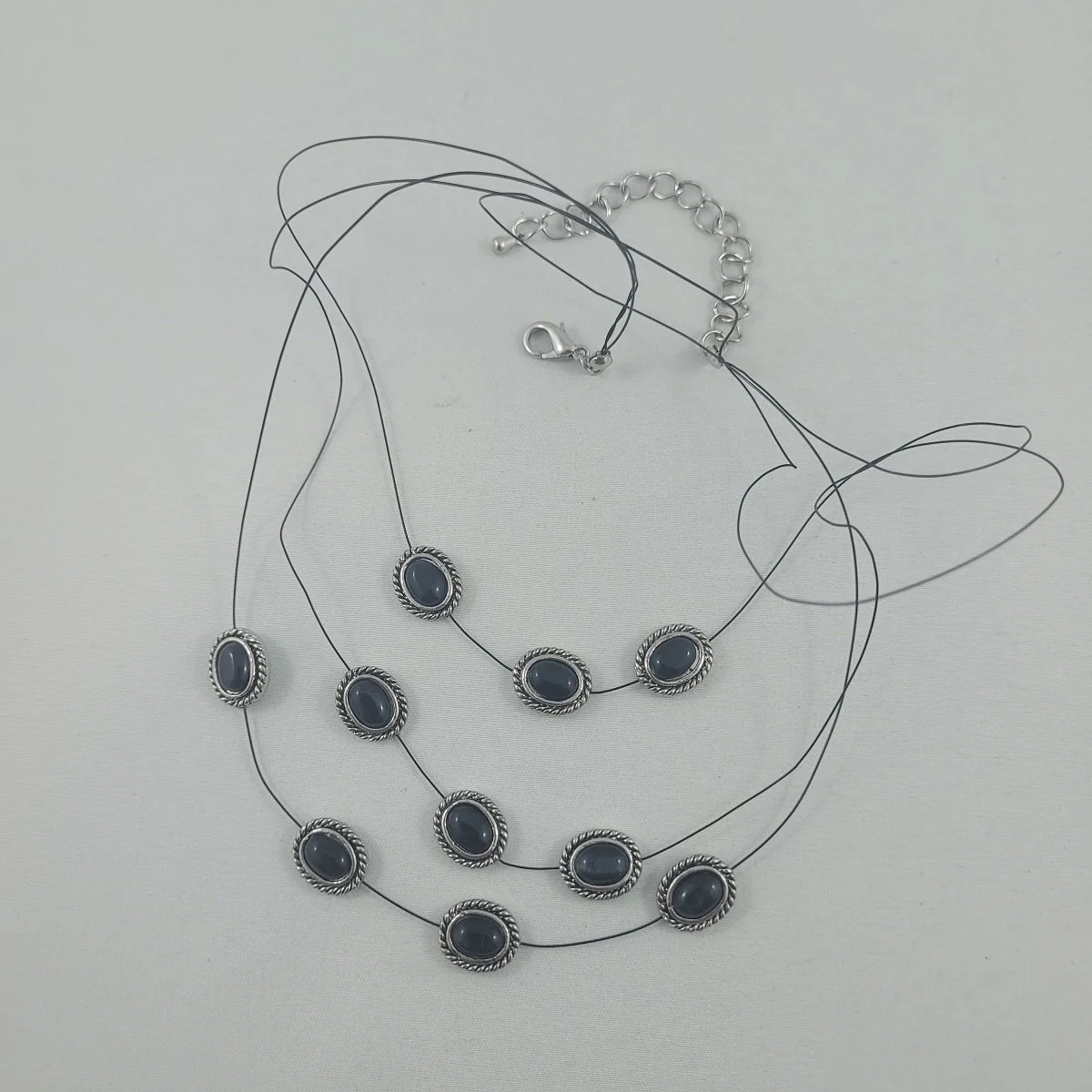 Triple Strand Black Cable Wire Antiqued Silver Oval Slide Inset Black Cat's Eye Chatoyant Scapolite Cabochon 21 Inch Matinee Necklace.jpg
