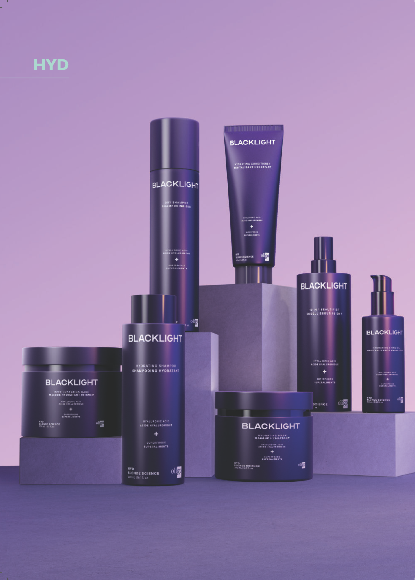 Collection of purple skincare and haircare products labeled 'BLACKLIGHT' displayed on purple surfaces against a purple background.