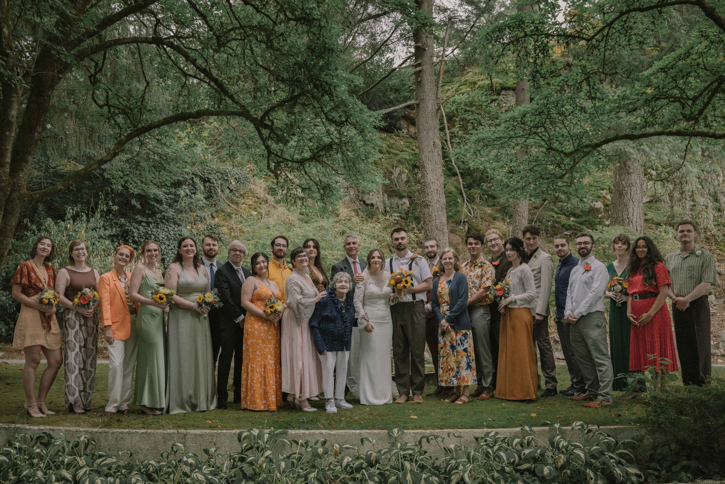 A colourful bridal party and family members surrounded by greenery at Minnekhada Regional Park.