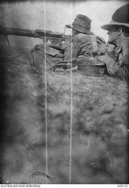 Two men of the 9th Lighthorse Regiment Machine Gun section firing a Vickers machine gun.