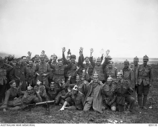  1st Division troops after their relief, sporting some of the spoils. A Lewis gun is in front.  