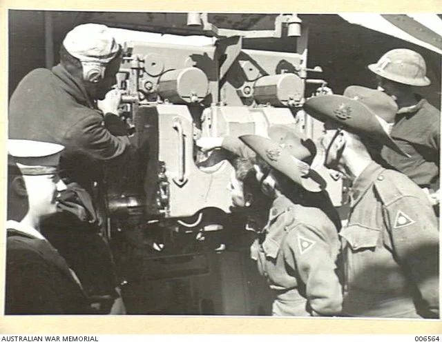  Crew explaining naval guns to AIF members on the way to Greece. 
