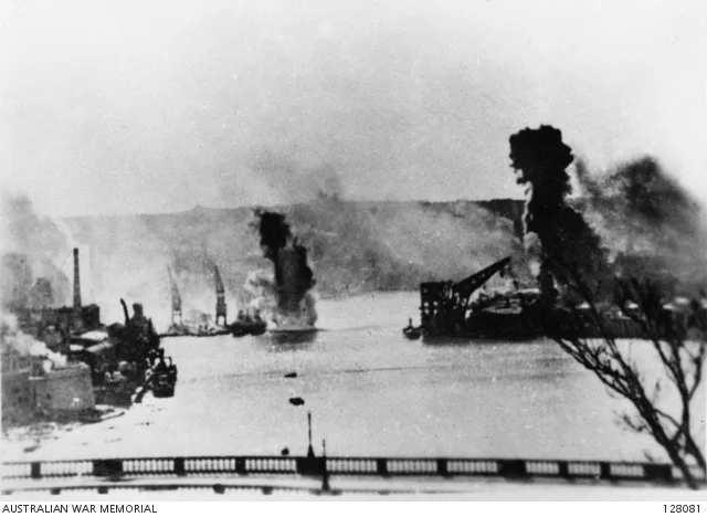  HMAS Perth (I) (left) and HMS Illustrious under attack in Malta Harbour.  