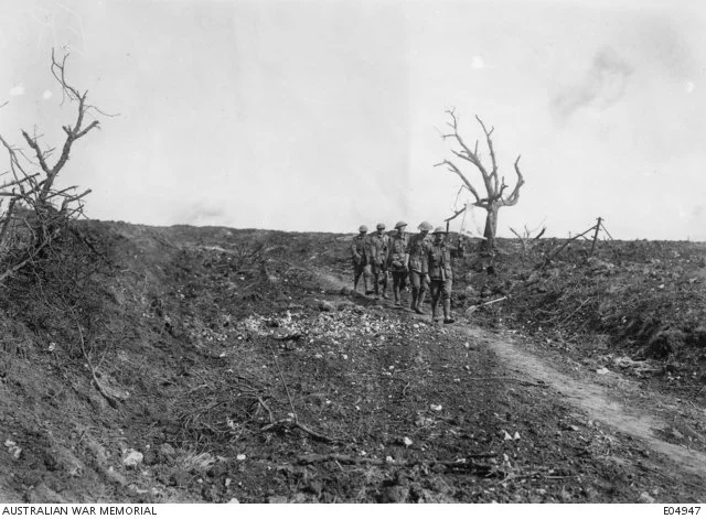  A stretcher party making their way back through Pozieres village during the subsequent fighting at Mouquet Farm.   Courtesy AWM 