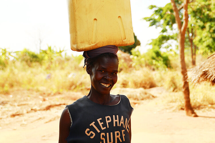 woman carrying water canister.jpg
