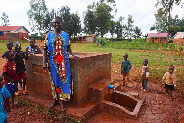 woman standing in from of the new well.jpg