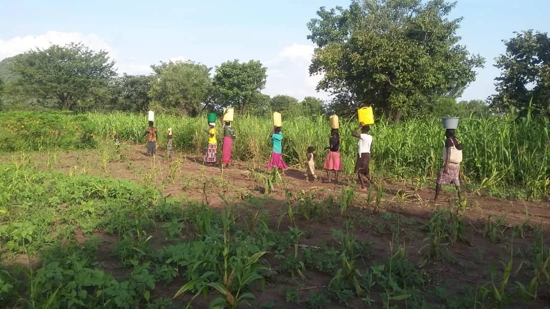 08_Women-Children-Jerry-Cans-Maize-Field_DUPLICATE.jpeg