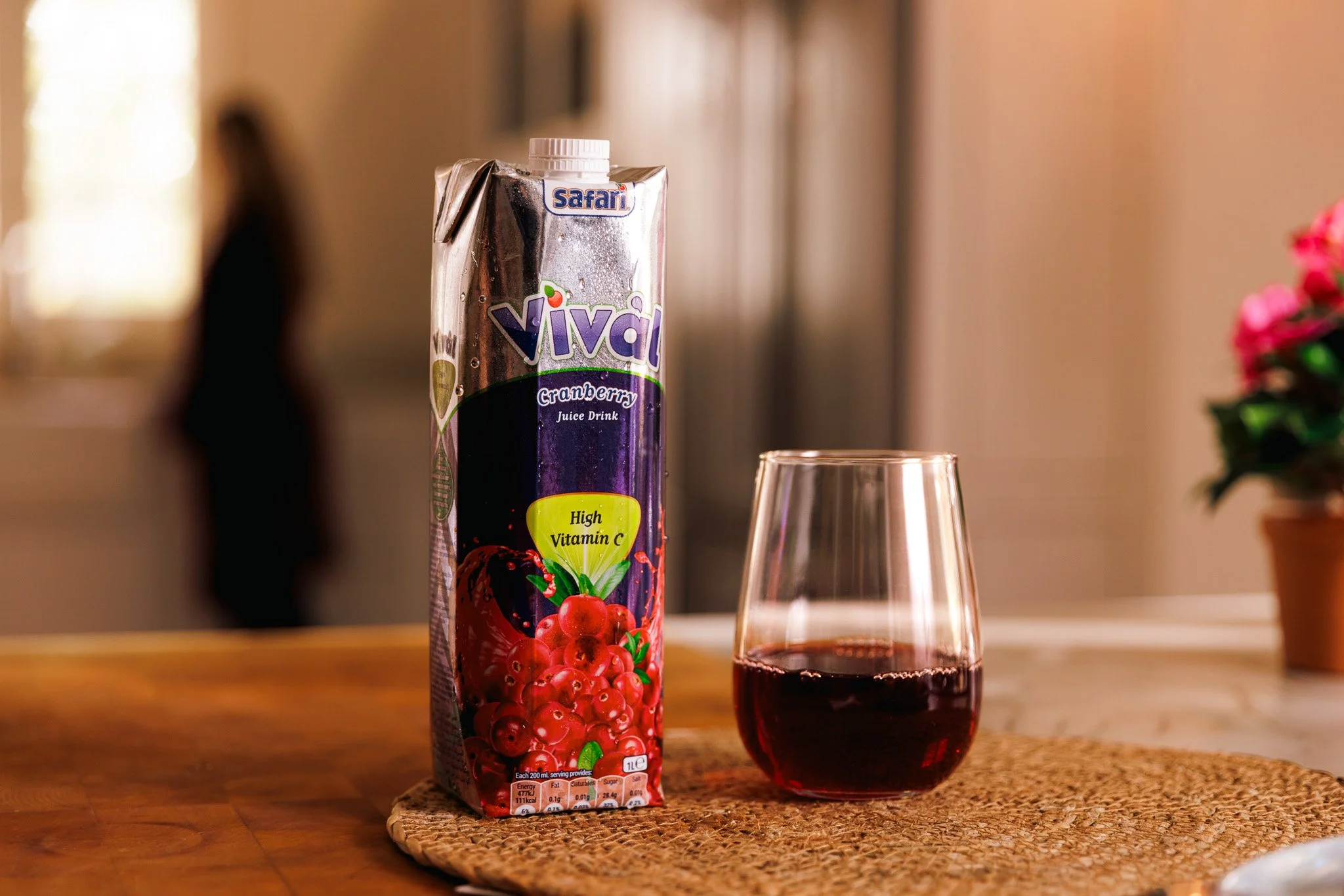 vival juice box on dining table, glass filled with juice