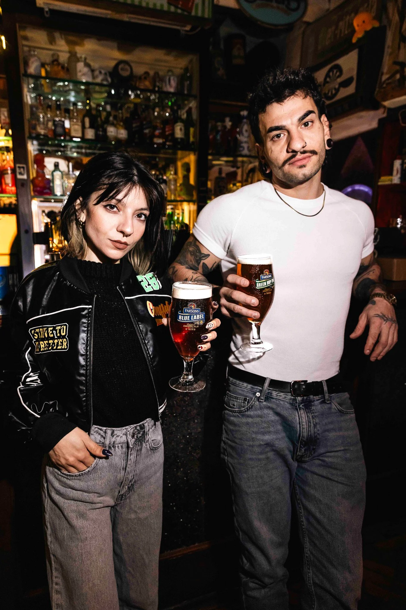 two cool alternative models holding classic brews glasses, photoshoot