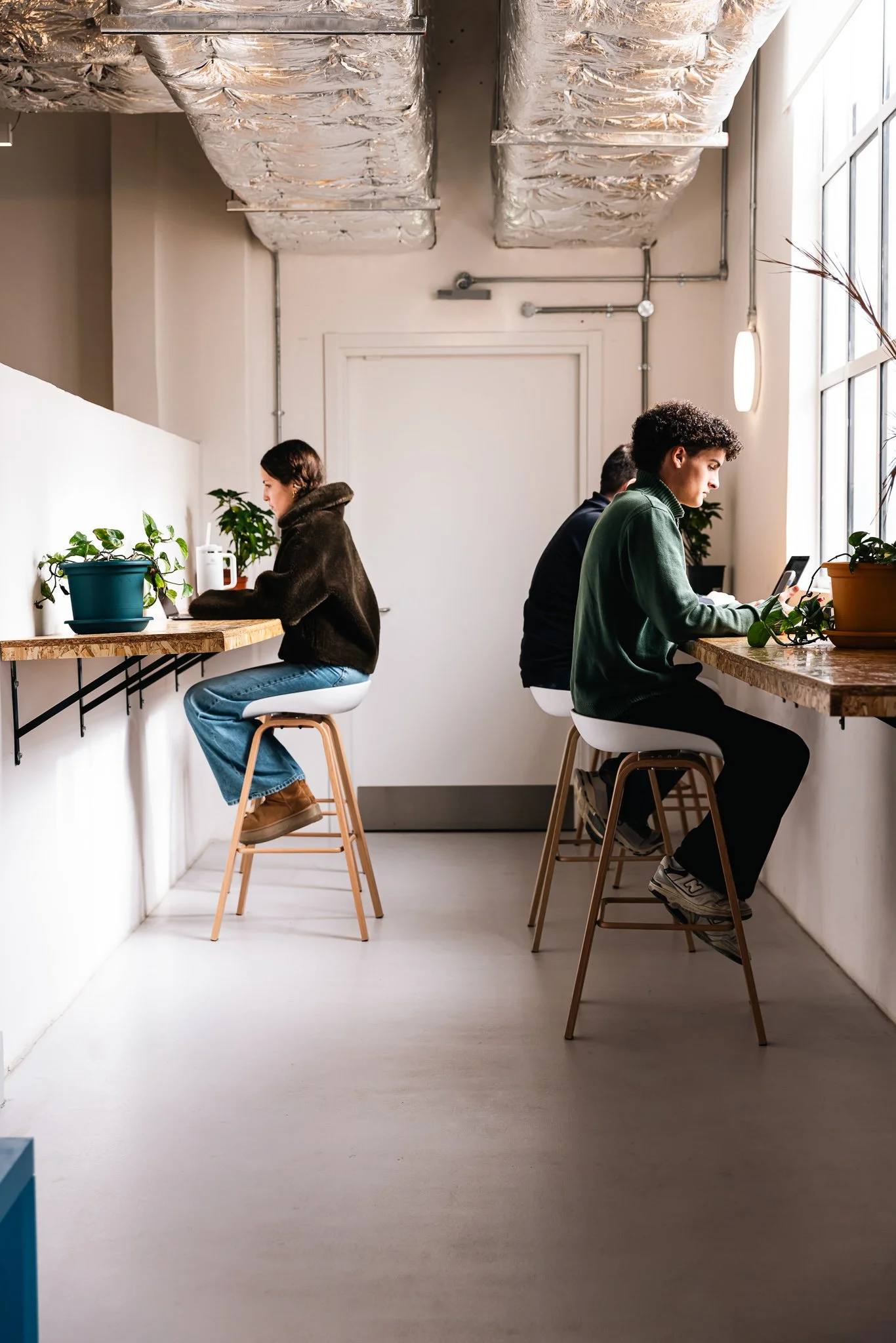people inside the vats coworking space, working on their laptops, interior photography