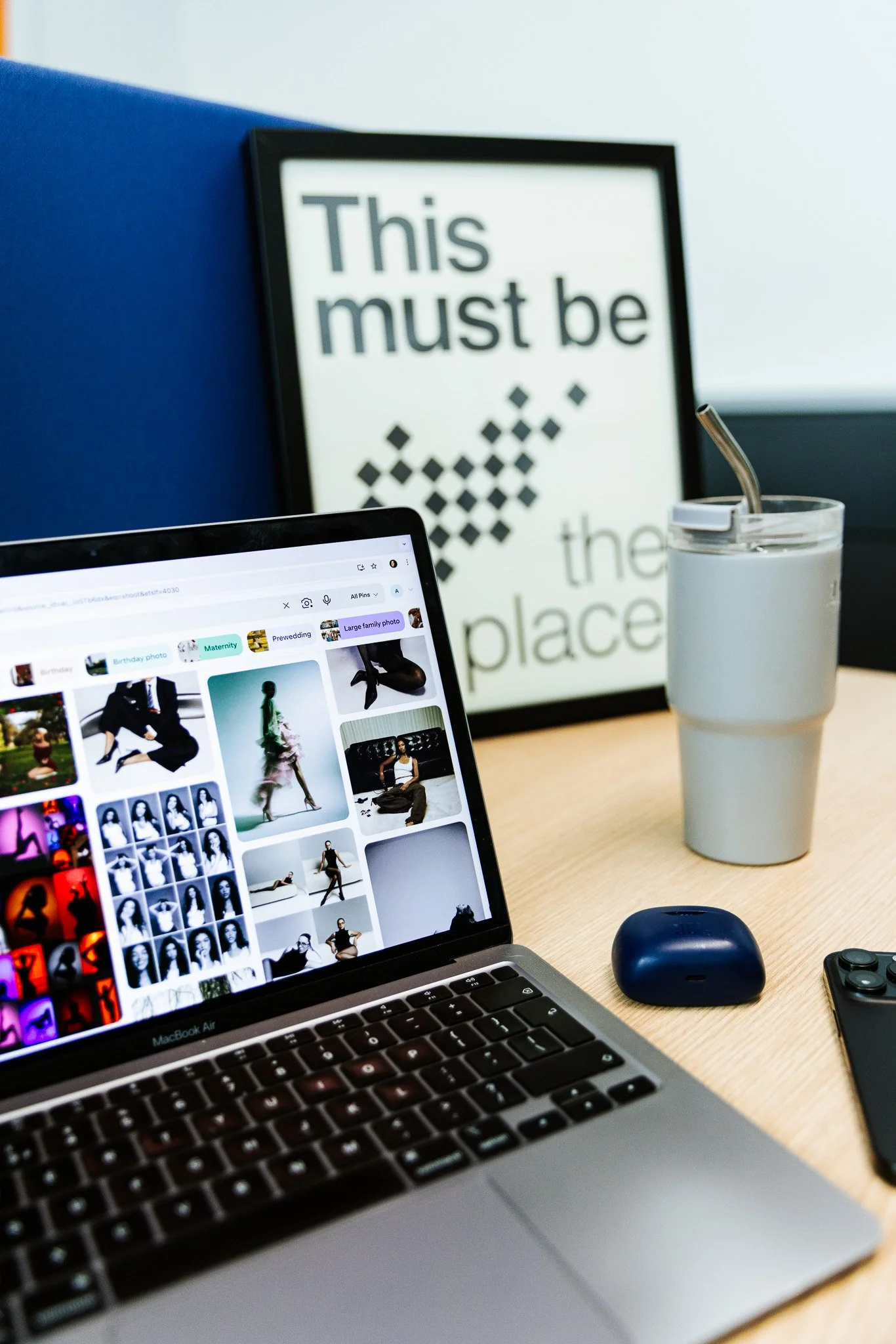 laptop with a moodboard, on a desk, water bottle
