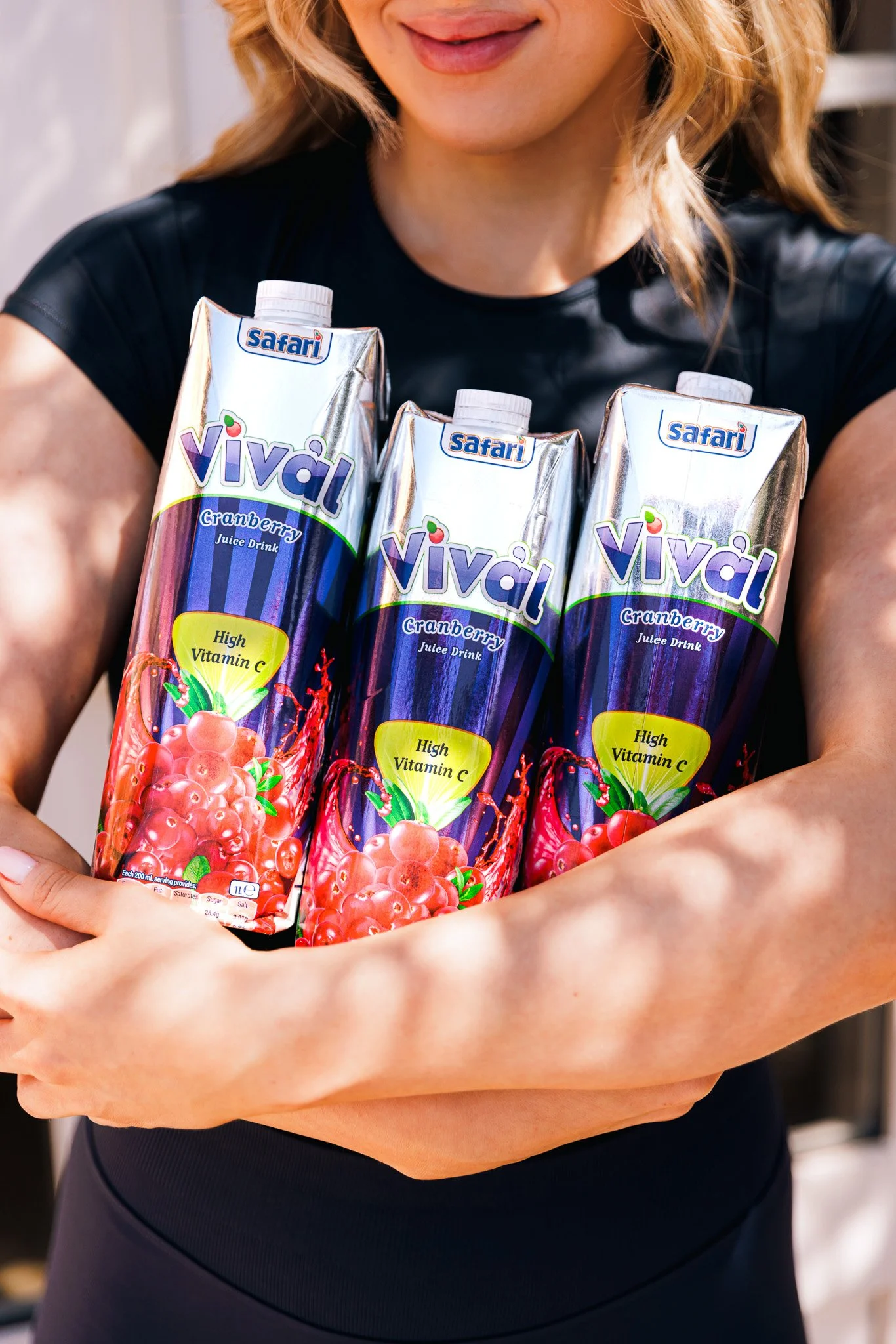 woman holding vival juice boxes in her hand