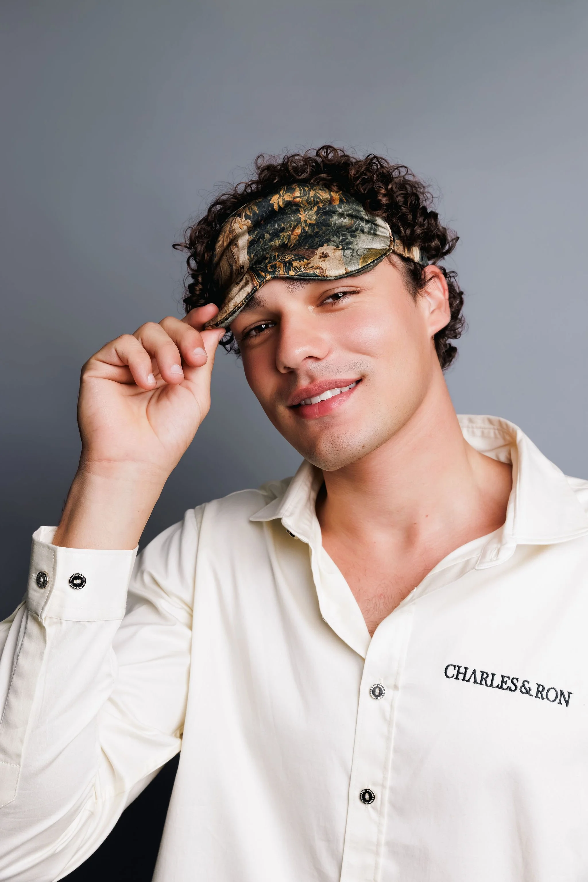 man smiling wearing a sleepmask by charles and ron and heritage malta