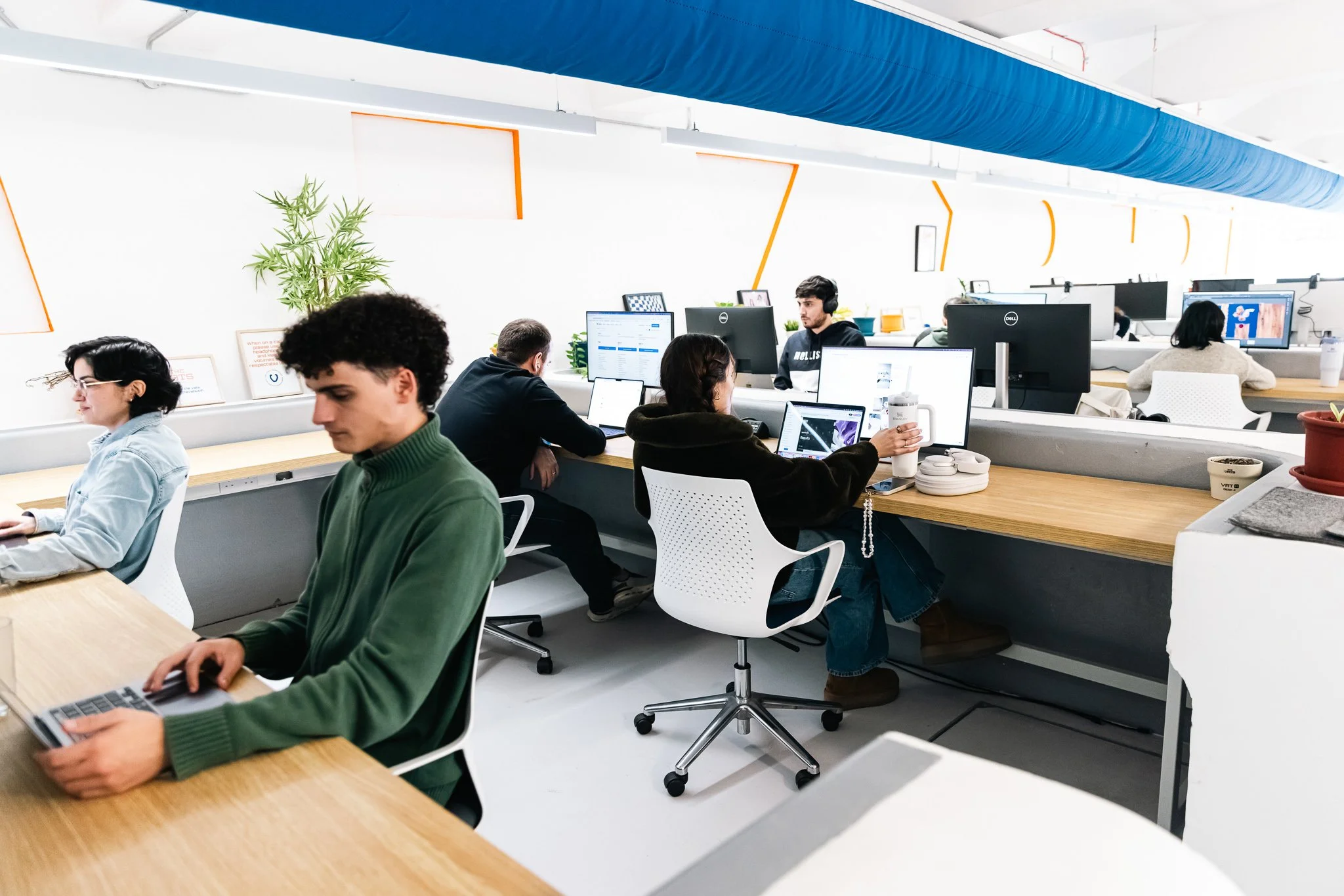 people inside the vats coworking space, working with monitors and laptops, interior photography