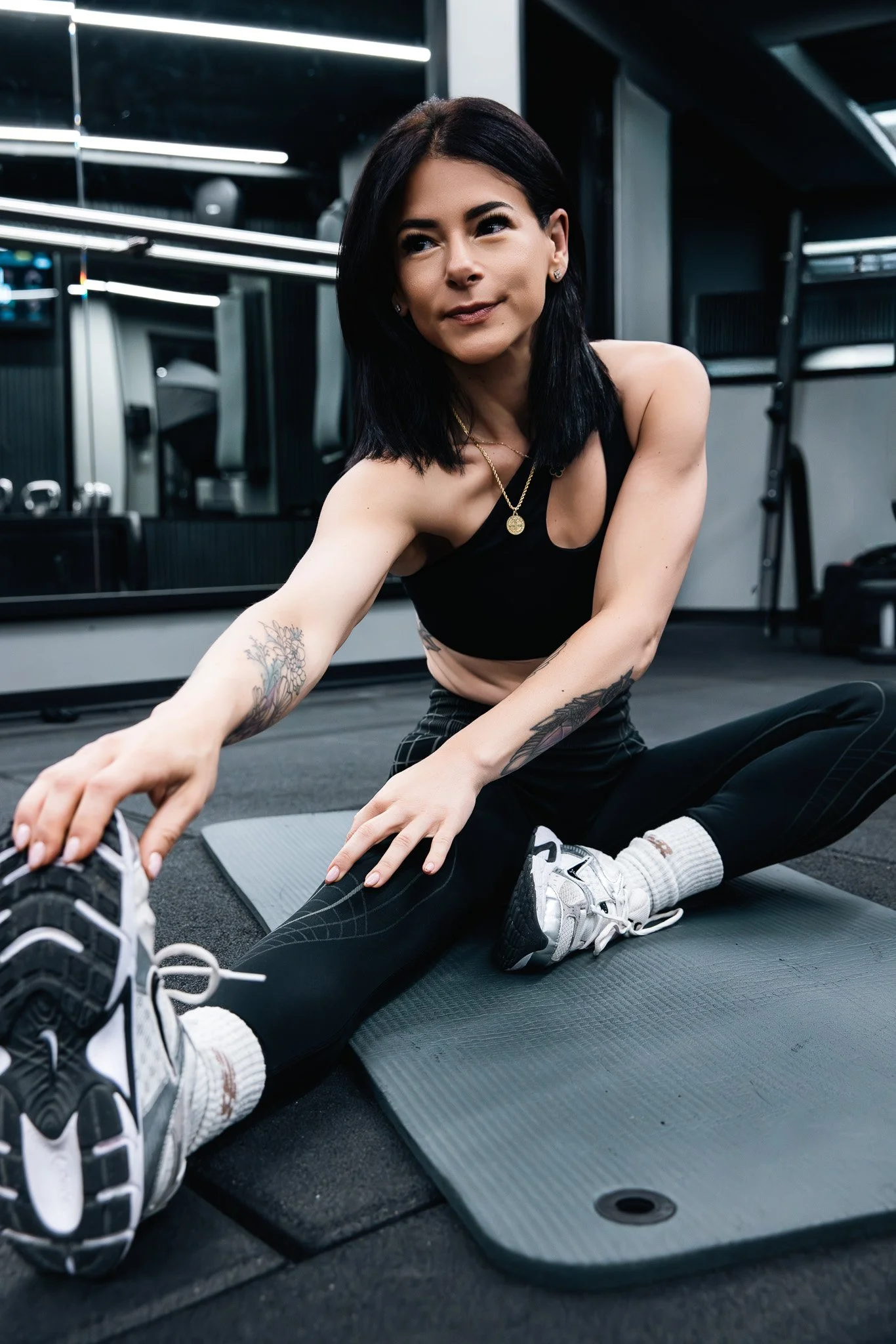 female trainer stretching at the gym, brand shoot