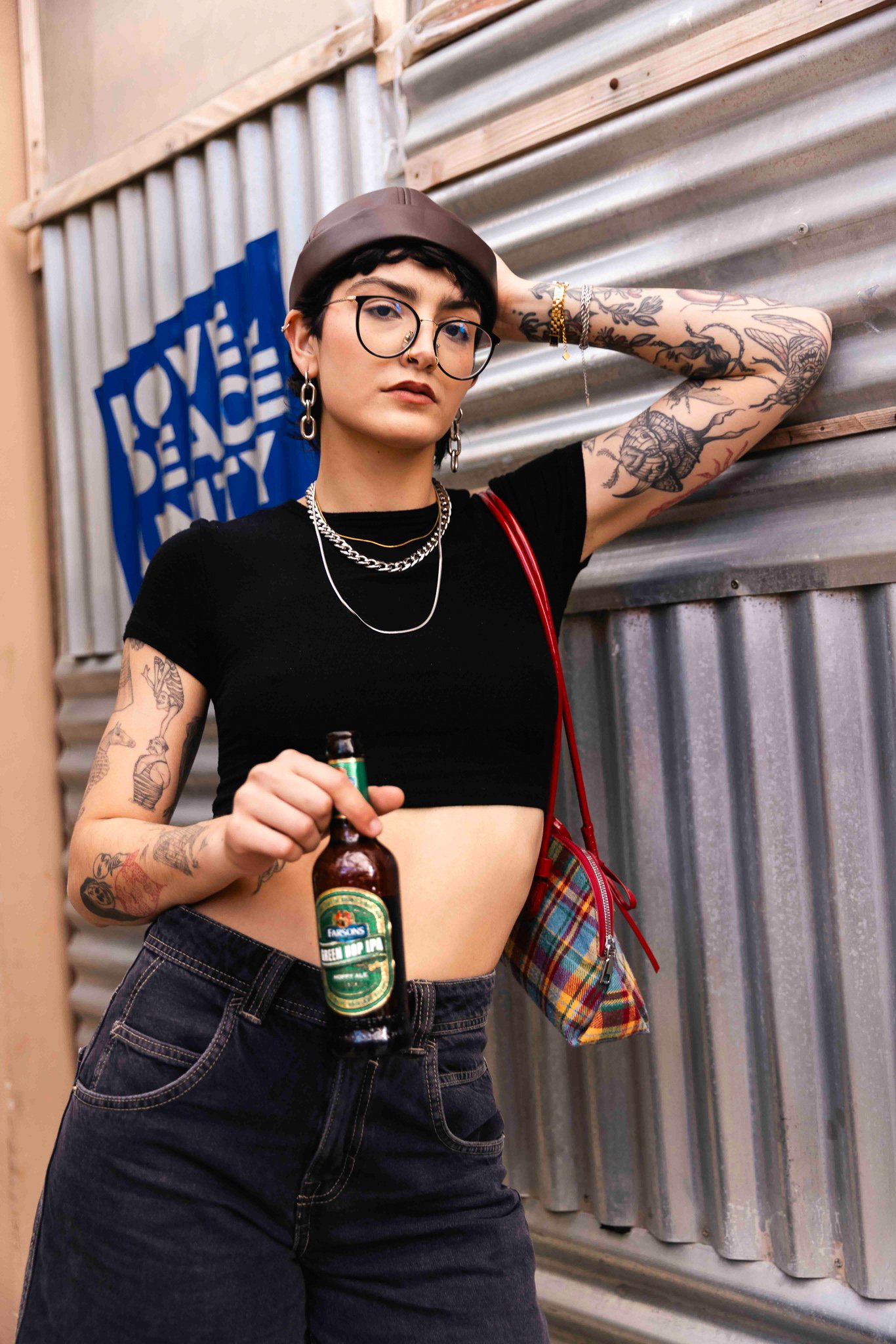 cool alternative female model holding a green hop ipa beer bottle, classic brews photoshoot