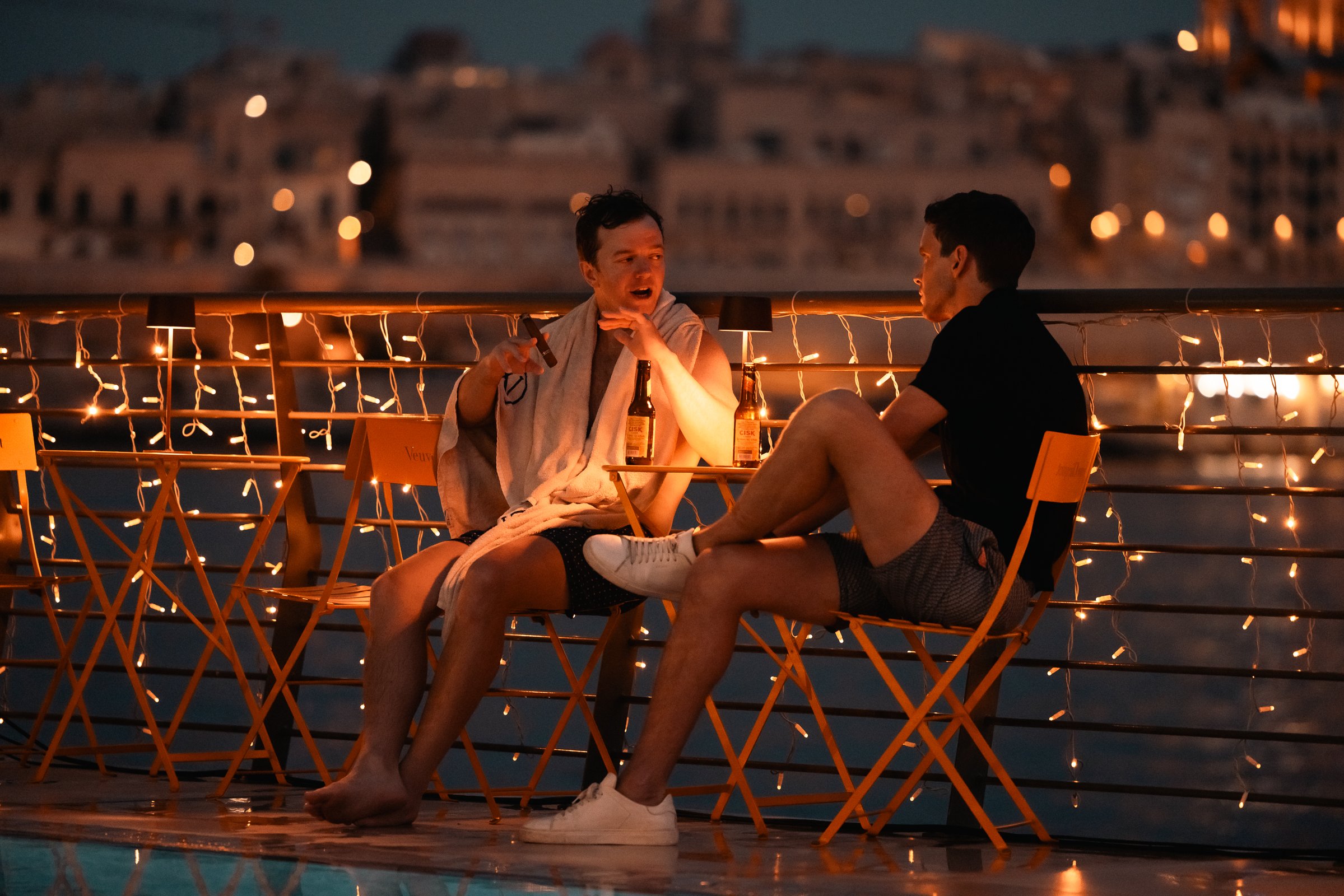 manta by the sea, two guests having a conversation, event photography.