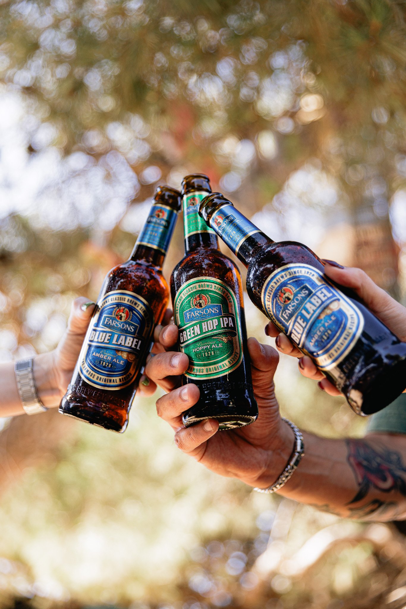 classic brews bottles, green hop ipa, blue label, outdoors, summer time photoshoot