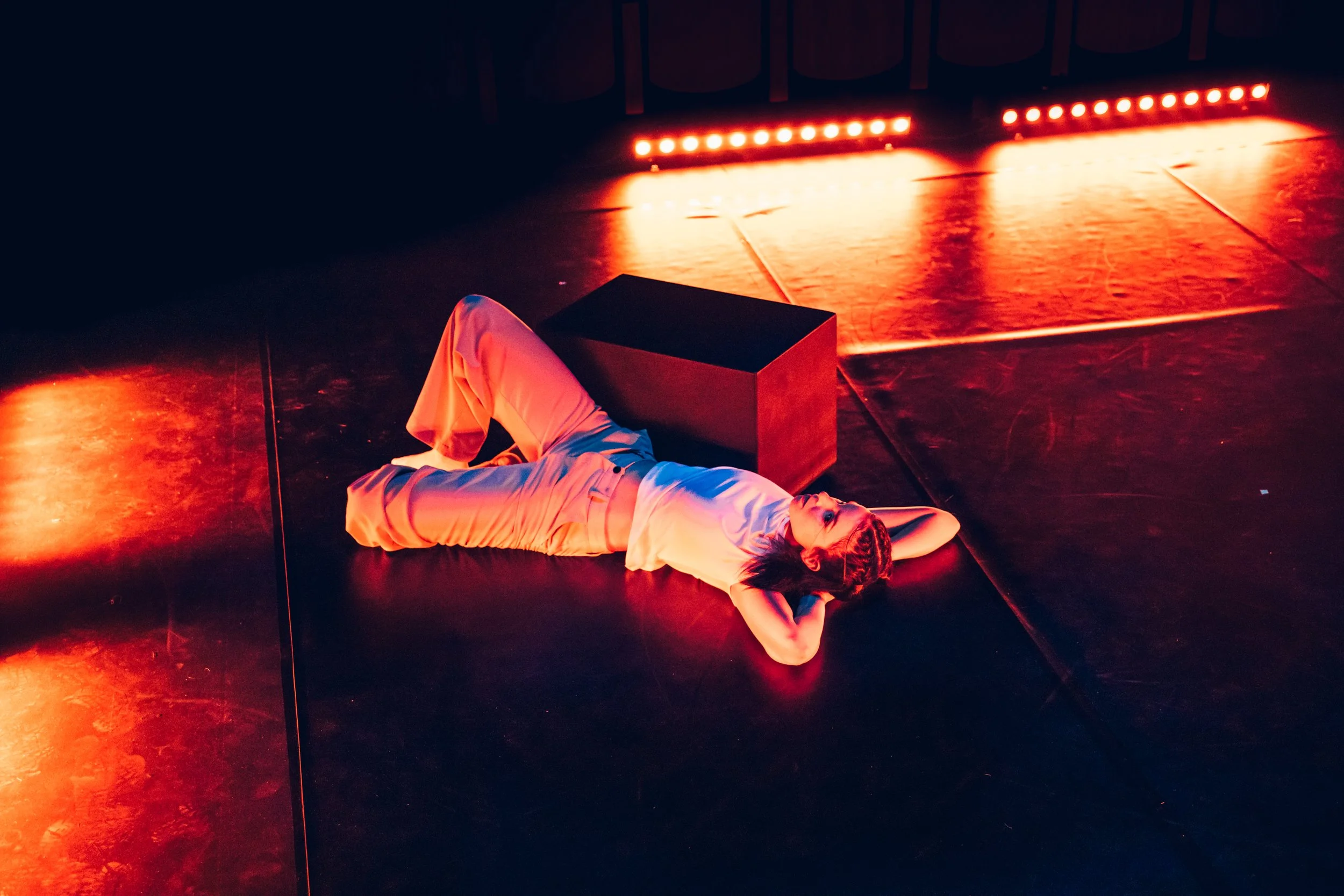 dancer on stage, moody lighting, dance photography.