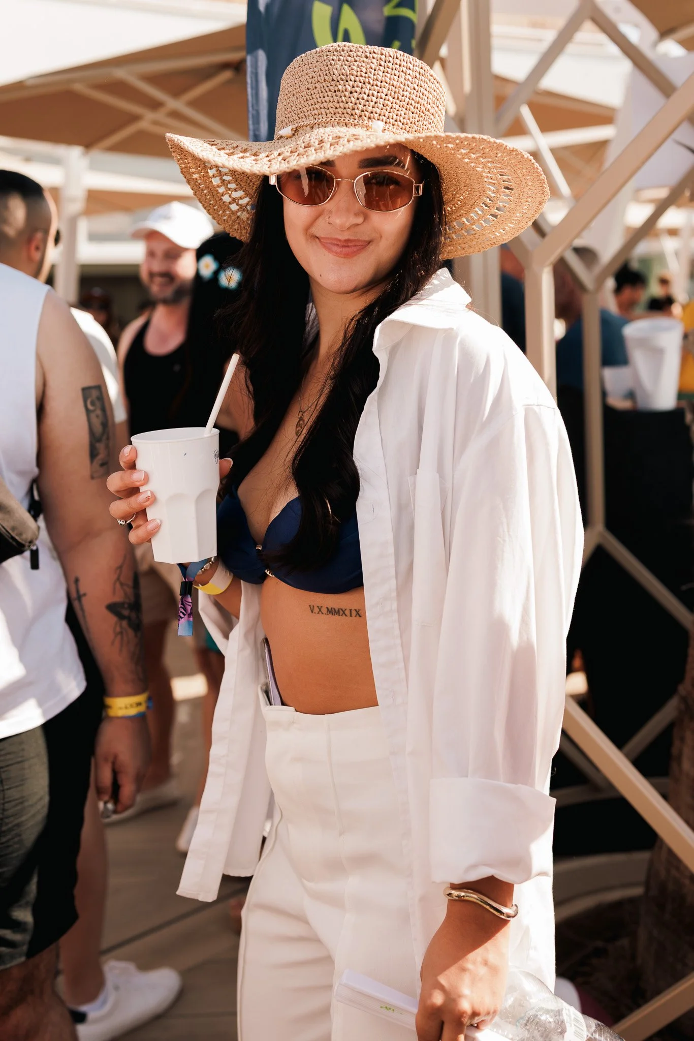 Woman in a hat by the pool, igaming event summer party, photography.