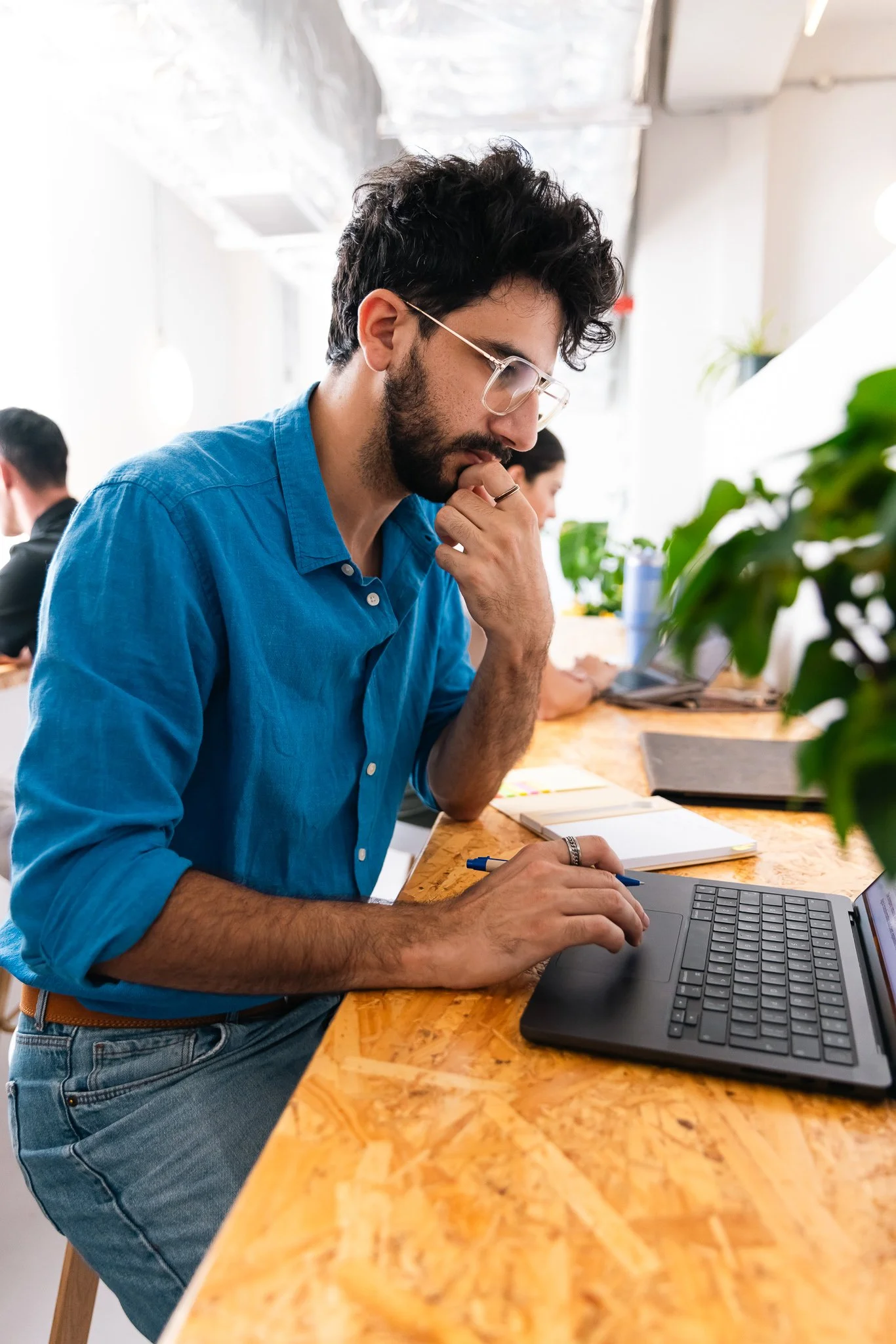 man at a desk on his laptop working, the vats coworking space