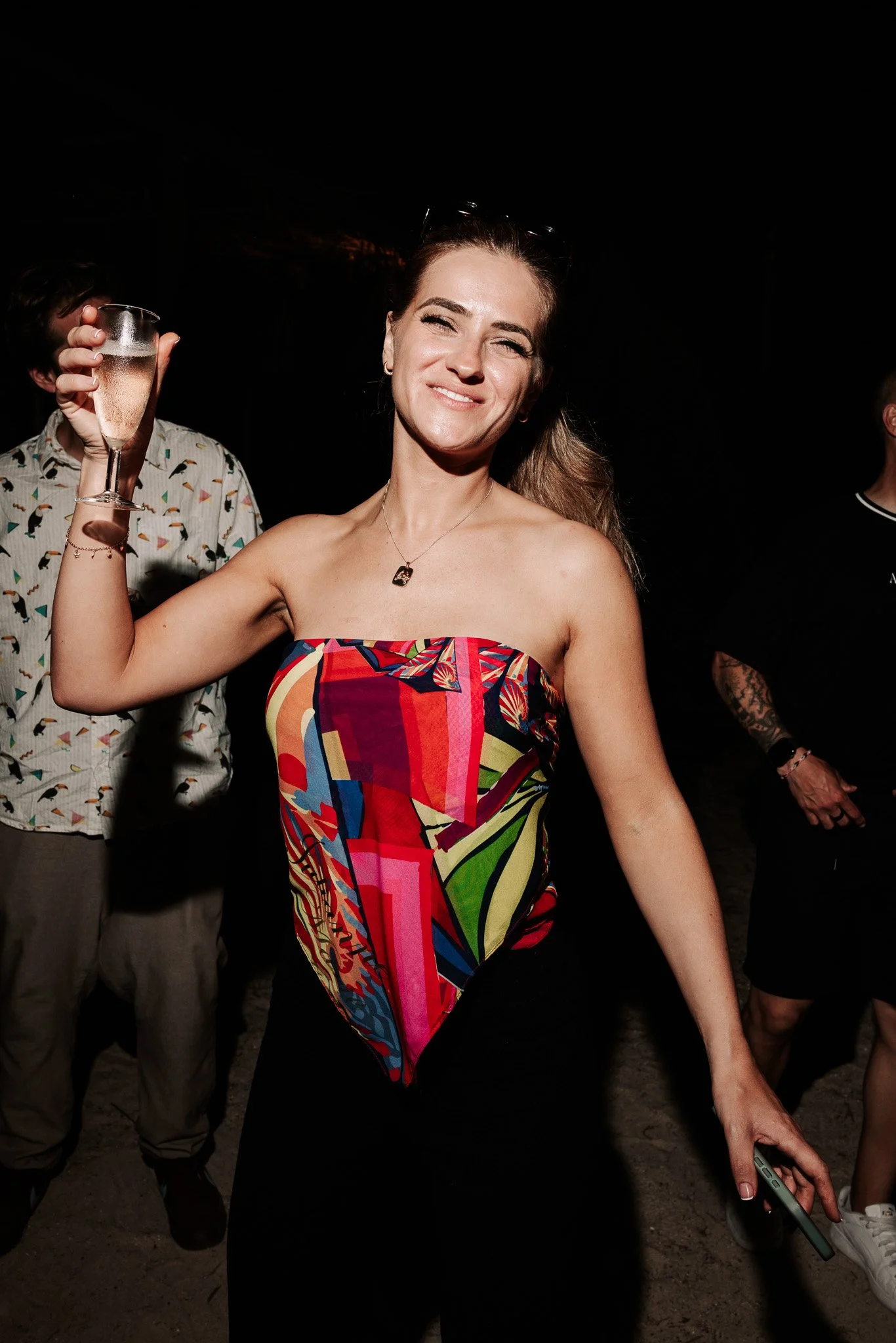 woman dancing with drink in hand, event photography.