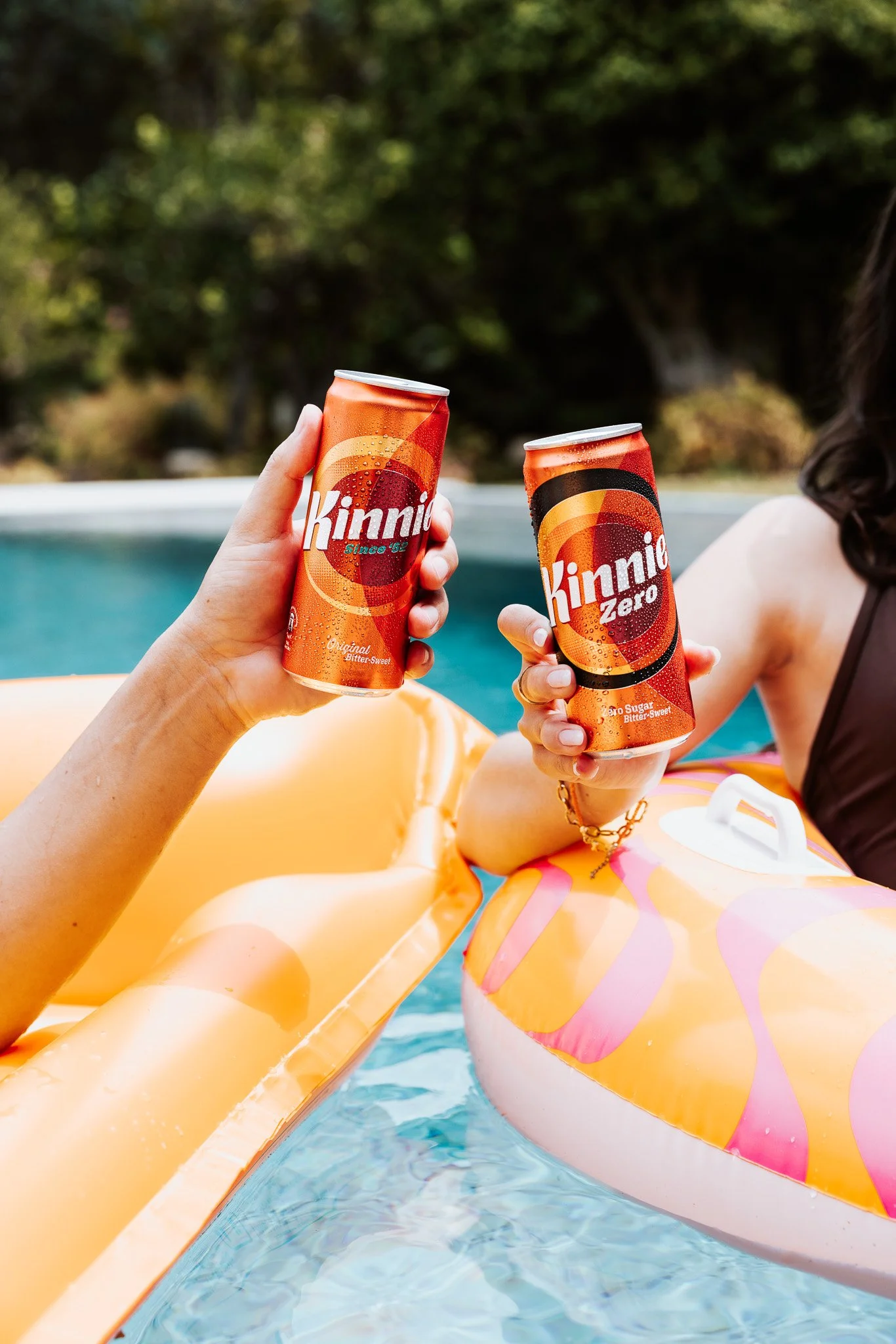 kinnie cans and pool floaties outdoors in the pool, summer shoot