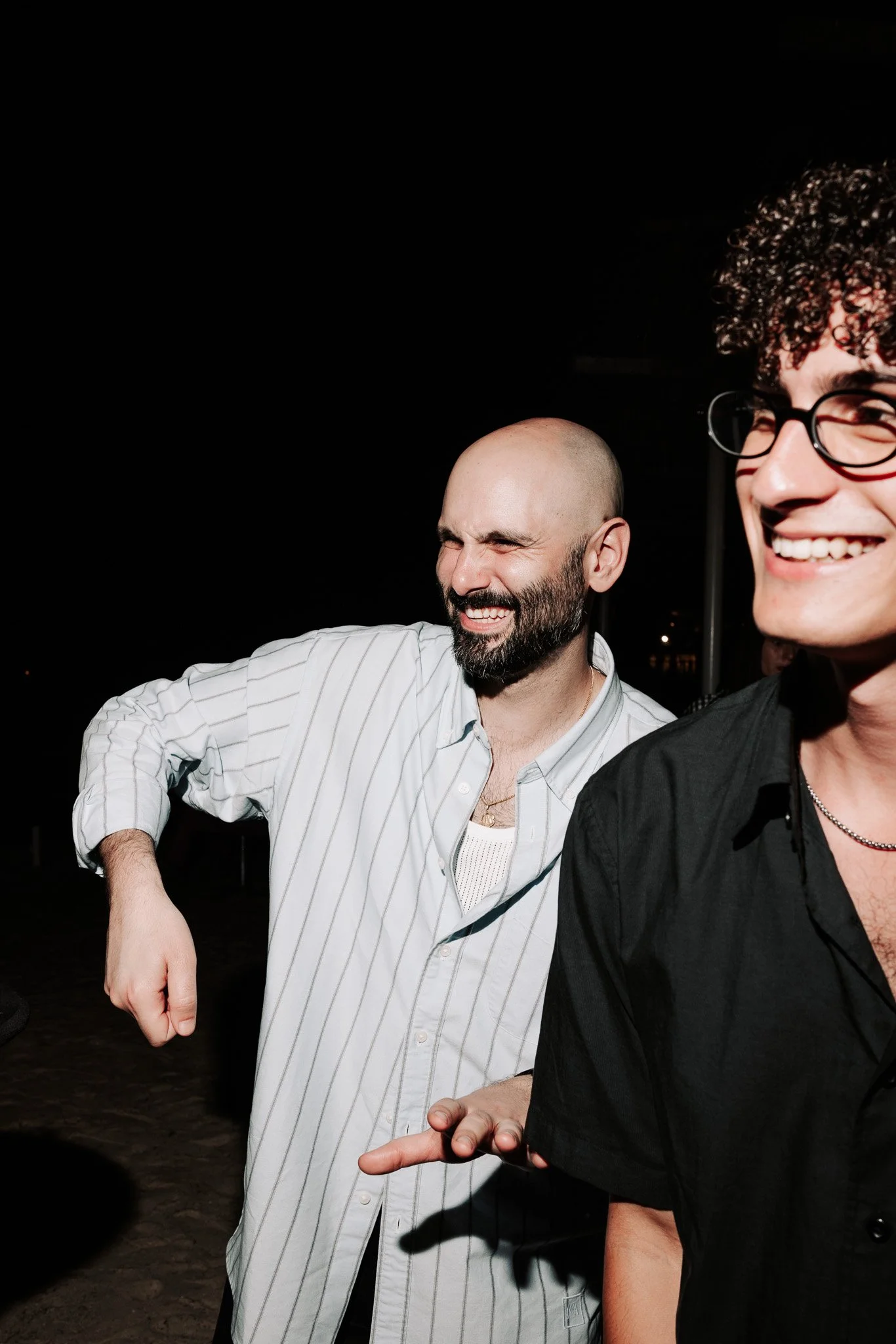 two men laughing and dancing, event photography.